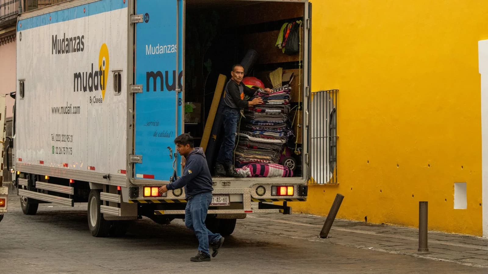 Déménageurs chargeant un camion devant un immeuble